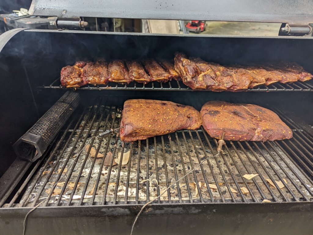Smoking meat on a pellet smoker with a smoking tube to add extra smoke

